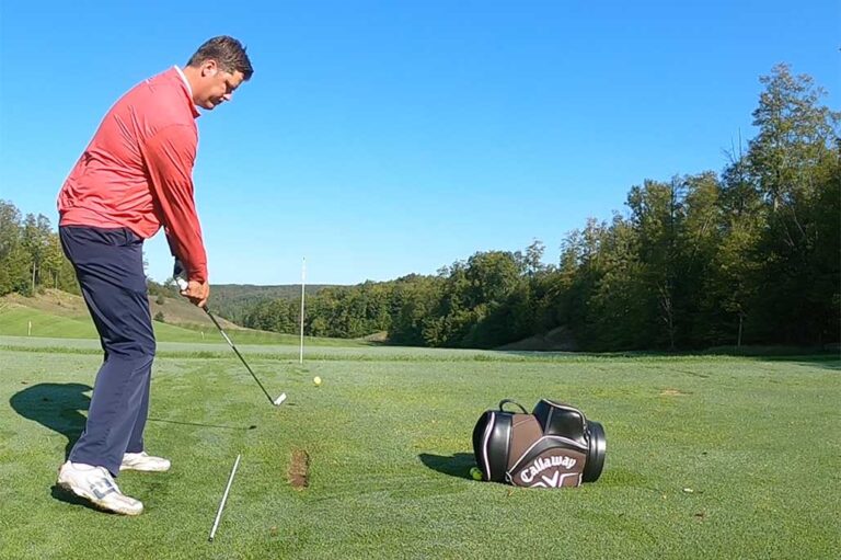 Joe-Charles-Practicing|Screen Shot 2018-09-12 at 9.44.10 AM (002)|TGAlogo-pc Tall man in read shirt getting ready to swing a golf club | golf practice station